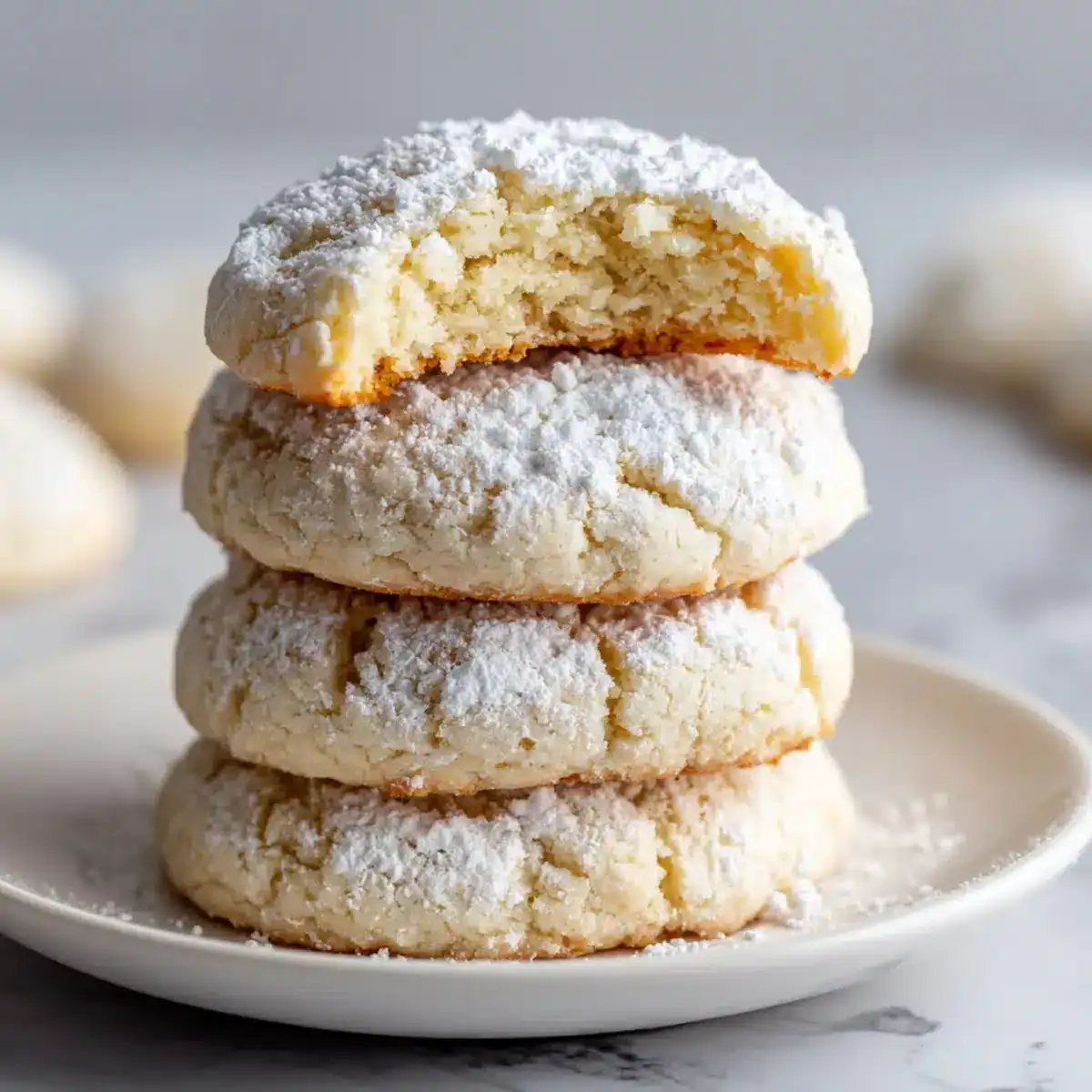 Soft homemade sugar cookies coated with powdered sugar, ideal for cookie lovers and holiday baking. Great for snacks and special occasions.