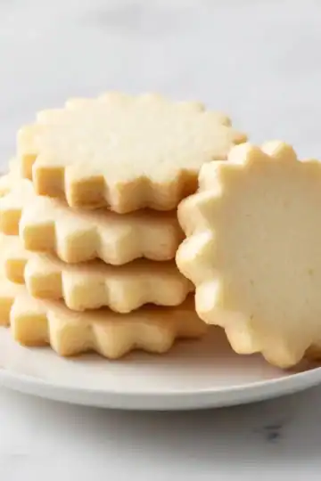 Buttery shortbread cookies on a white plate, perfect for baking and snack desserts.