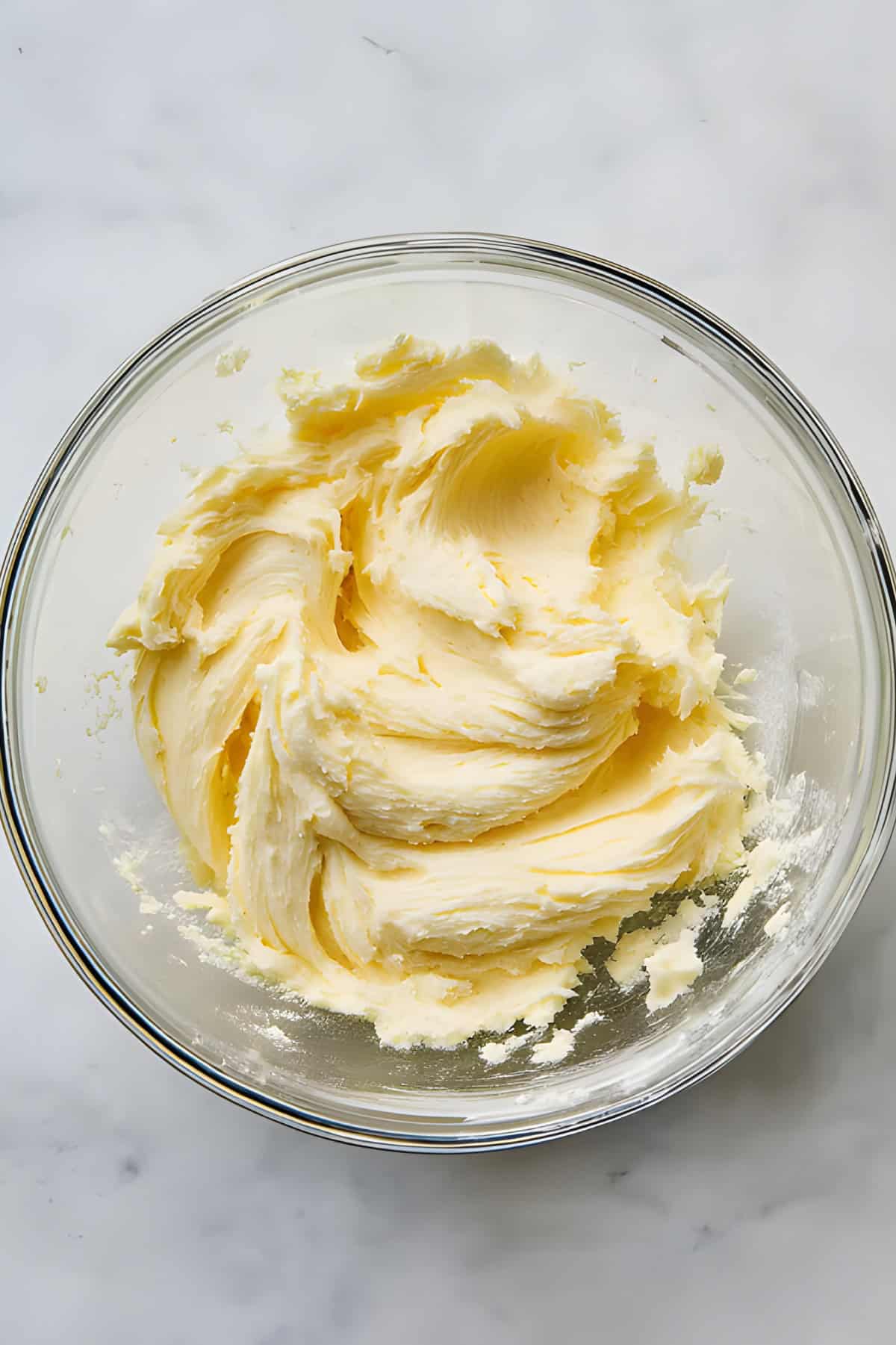 Smooth, freshly prepared cookie dough in a glass bowl.