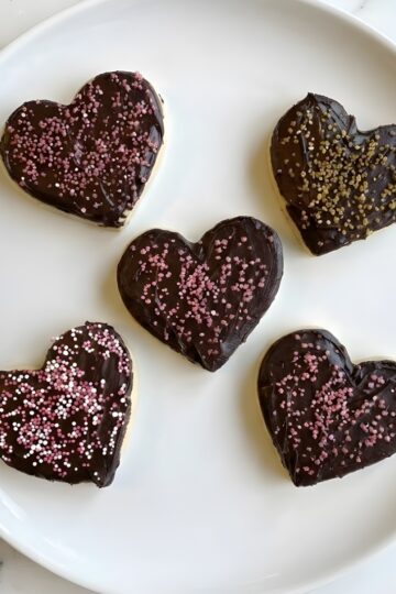 Delicious heart-shaped cookies with rich chocolate and colorful sprinkles for Valentine's Day. Perfect for special occasions.