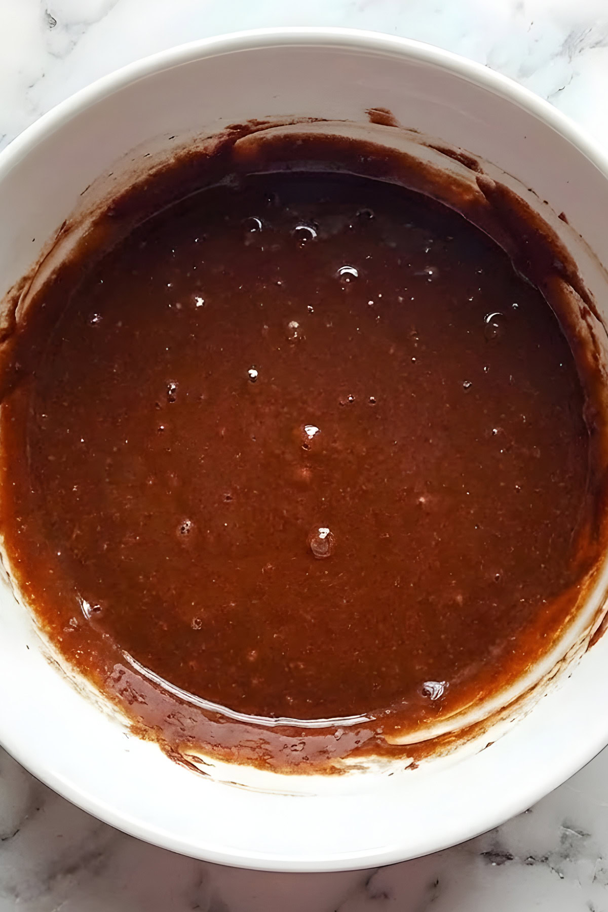 Delicious homemade chocolate sauce ready for desserts or ice cream. Perfect for adding rich flavor to your treats.
