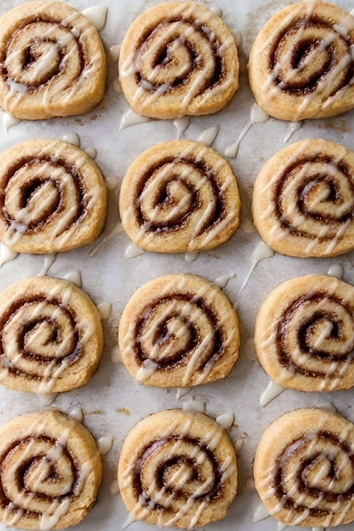 Delicious cinnamon roll cookies with icing drizzle, perfect for breakfast or dessert. Easy homemade sweet treat.