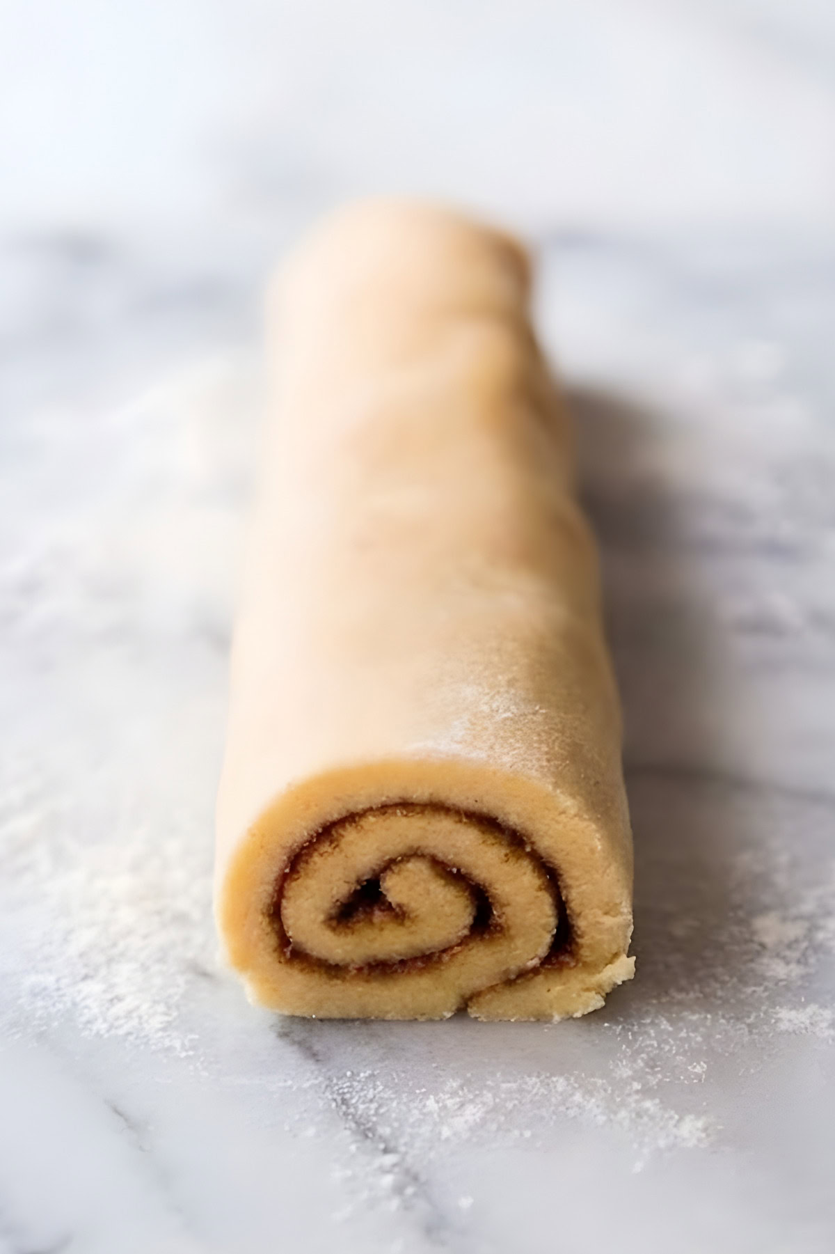 Decorative cookie dough rolled with chocolate swirl center for baking.