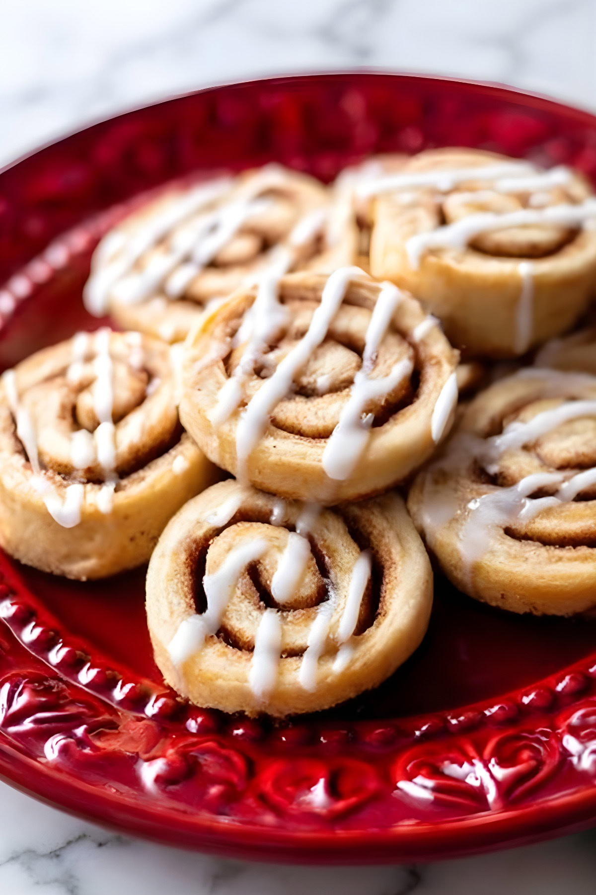 Delicious homemade cinnamon rolls drizzled with white icing, perfect for breakfast or dessert.