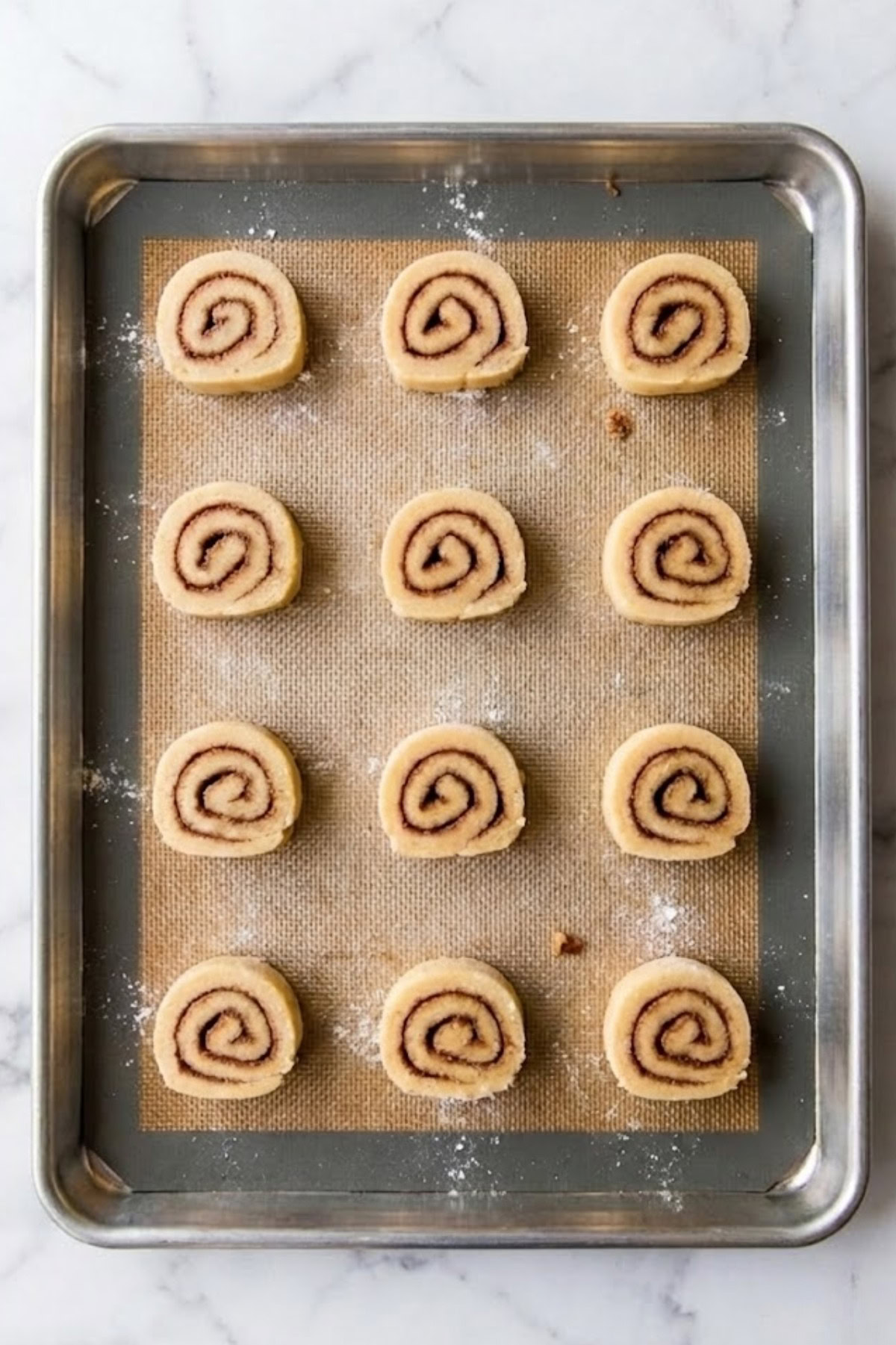 Delicious cinnamon swirl cookies on a baking sheet, ready to bake.