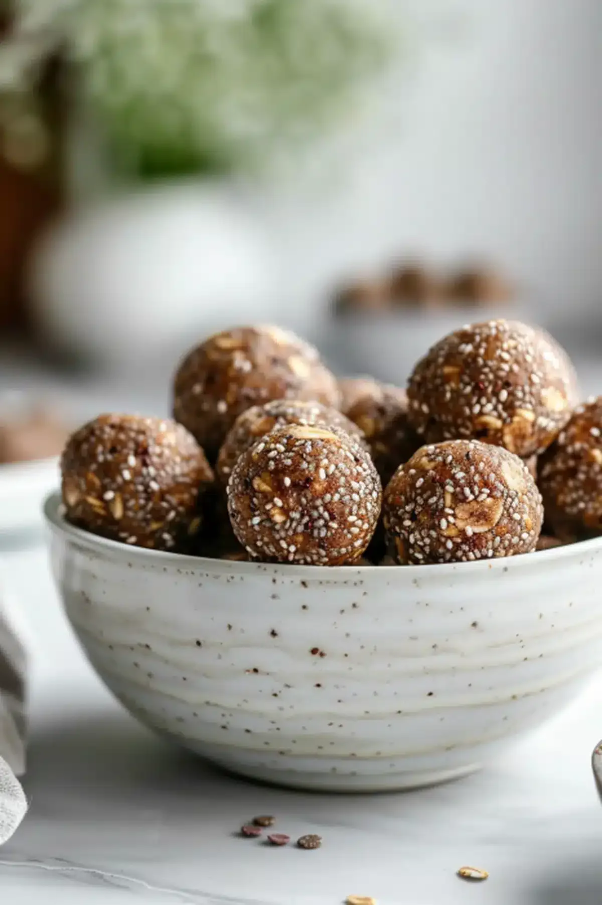 Delicious no-bake peanut butter chia seed energy balls in a white bowl.
